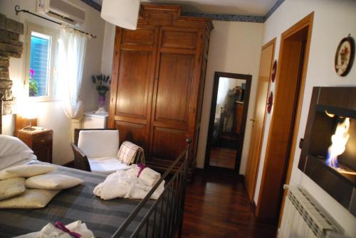 a bedroom with a bed and a chair in it at Casa tipica siciliana patronale home BedandBreakfast TreMetriSoprailCielo Camere con vista, colazione interna in terrazzo panoramico in Caltagirone