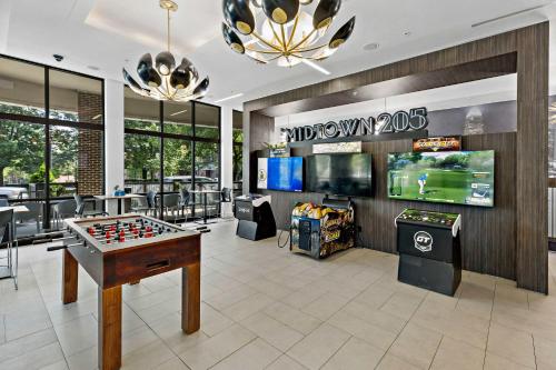 a game room with a foosball table and video games at Urban Comfort 1BD Sleeps 6 DT 5 Min Gym & Parking in Charlotte