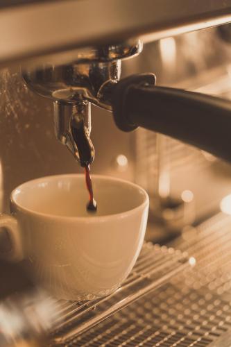 a coffee being poured into a white bowl at Gartenhotel Maria Theresia in Hall in Tirol