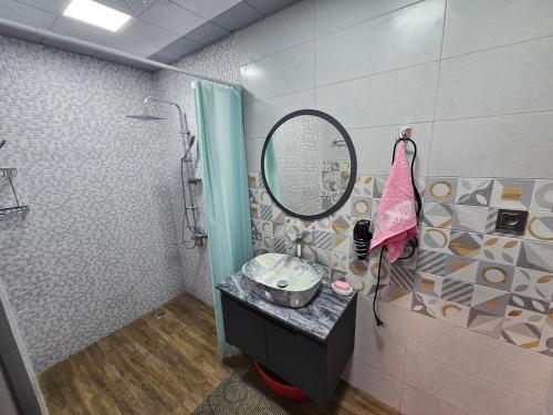 a bathroom with a sink and a mirror at Lush Paradise in Gabala