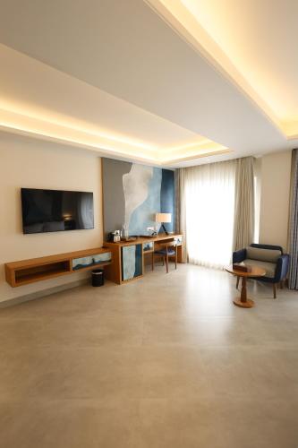 a living room with a flat screen tv and a couch at Royal Bishnu in Baharampur