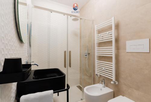 a bathroom with a shower and a toilet and a sink at Marechià Luxury Home by Vivimy in Gallipoli