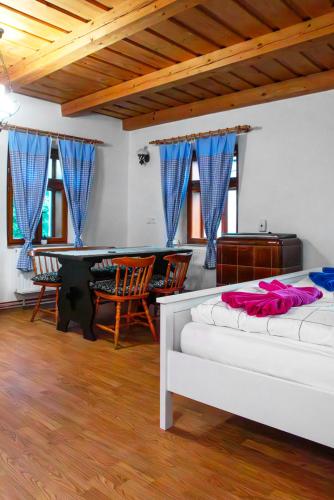 a living room with two beds and a table at Na Chaloupce in Kladky
