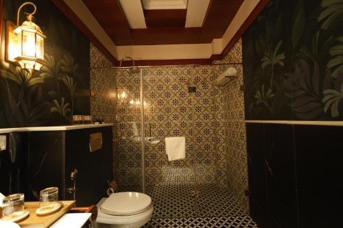 a bathroom with a shower and a toilet in it at Royal Bishnu in Baharampur