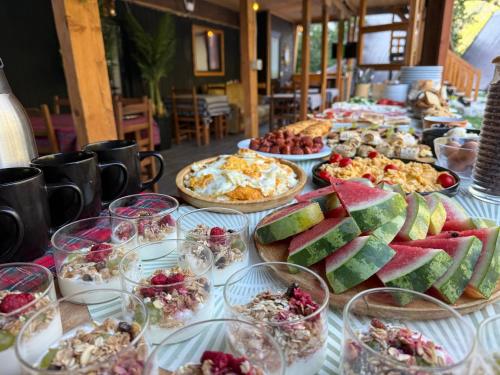 a long table with many plates of food on it at Thethi Villas in Theth