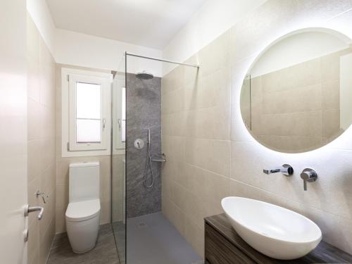 a bathroom with a sink and a toilet and a mirror at Ca' dei Vigneti in Colà di Lazise