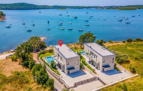 an aerial view of a large house with a body of water at Cozy Home In Medulin in Medulin