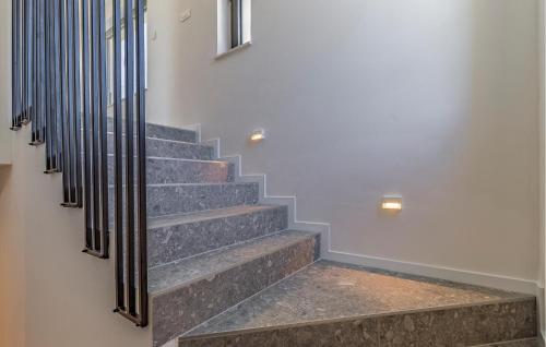 a staircase with stone steps and metal railings at Cozy Home In Medulin in Medulin