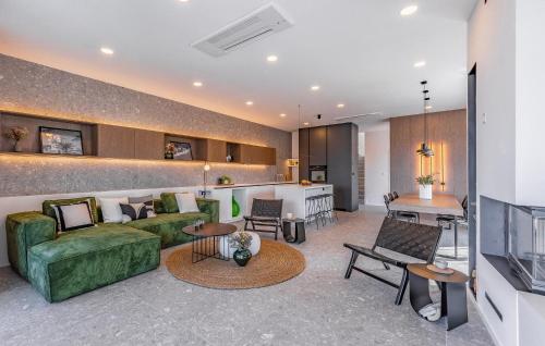 a living room with a green couch and a table at Cozy Home In Medulin in Medulin