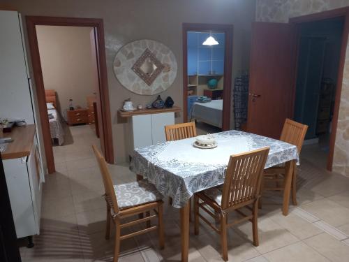 a dining room with a white table and chairs at Paradiso House in Torre Ovo