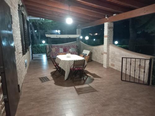 a table and chairs on a patio at night at Paradiso House in Torre Ovo