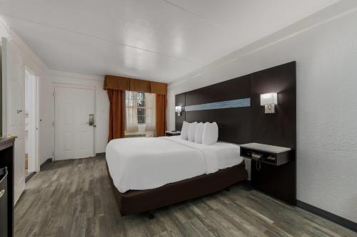 a large white bed in a hotel room at Quality Inn & Suites Airport in Charlotte