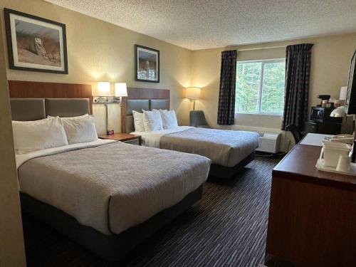 a hotel room with two beds and a window at Quality Inn near Toms River Corporate Park in Manchester Township