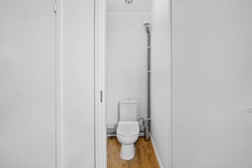 a bathroom with a white toilet in a stall at Angaar - Tallinn Airport in Tallinn