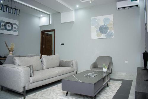 a living room with a couch and a coffee table at Care Appartement in Kinshasa