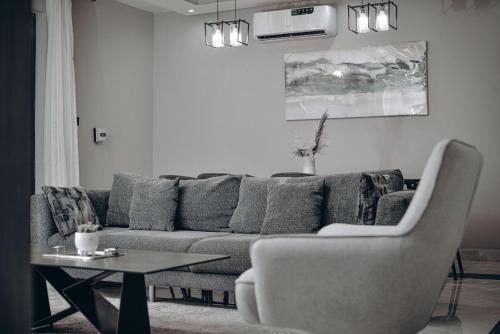 a living room with a couch and a table at Care Appartement in Kinshasa