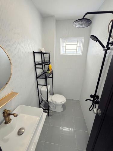 a bathroom with a white toilet and a sink at Yen Minh Resthouse in Ho Chi Minh City