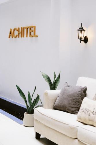 a living room with a couch and plants at ACHITEL Tarlac in Tarlac
