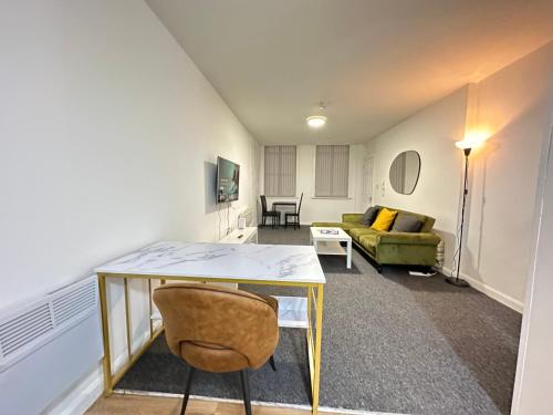 a living room with a table and a couch at The Bath Street Retreat in Ilkeston