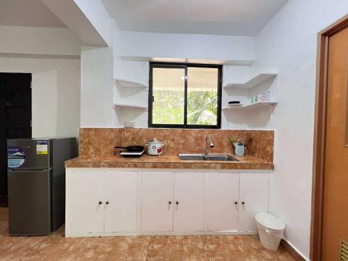 a kitchen with a sink and a window at Paradise Beach Apartment in Boracay