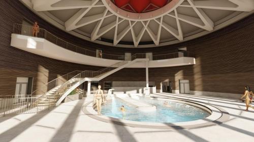 - une piscine dans un bâtiment avec des personnes dans l'établissement Appartement duplex de standing au cœur des Pyrénées, à Luchon