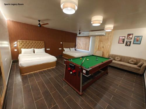 a hotel room with a pool table in a room at Hotel MGM Grand in Srikalahasti