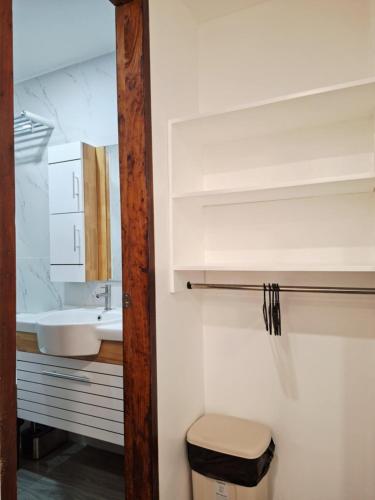 a bathroom with a toilet and a sink at Bonsai Jacuzzi Suites in Panglao
