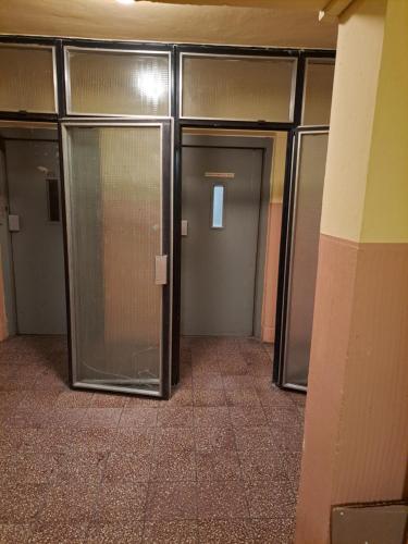 a row of elevator doors in a building at Moderní apartmán s balkonem v srdci Pardubic in Pardubice