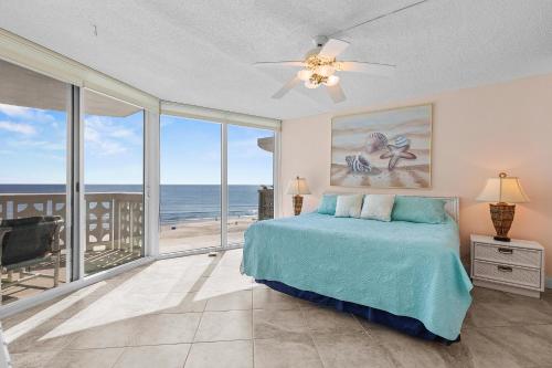 a bedroom with a bed and a view of the ocean at Golden Arms 803 in New Smyrna Beach