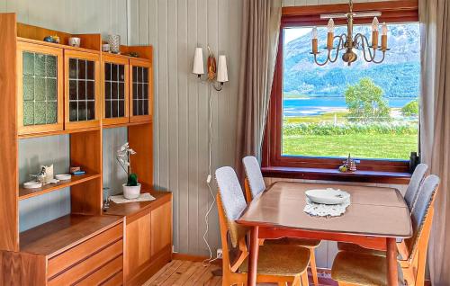 a dining room with a table and a window at Cozy Home In Elvegard With Sauna in Elvegård