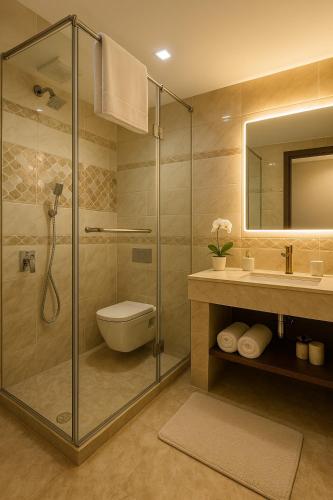 a bathroom with a shower and a toilet and a sink at The Four Season Dharamshala # Centrally Heated & Air Cooled # Scenic Mountain View # Big Parking # Near Market # Top Rated # Most Awarded # Premium Rooms # Bar # Terrace # Lift # Property Of The Year##BY ROYAL GROUP# in Dharamshala