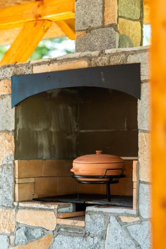 a pot sitting inside of a brick oven at Etno House Markovic in Kolašin