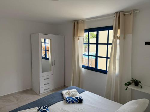 a bedroom with a bed and a window at Villa LiLo Private House with Heated Pool in Costa Teguise