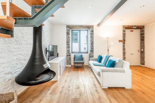 a living room with a couch and a fireplace at Port and Stone Villa in Funchal