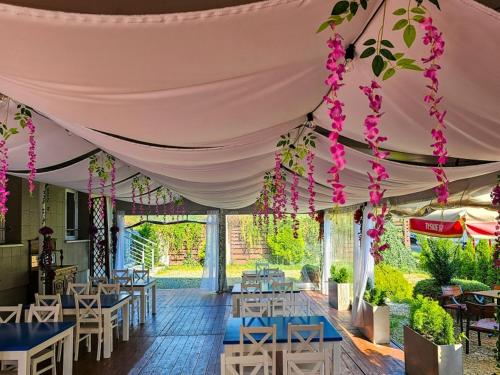 a tent with tables and chairs and flowers at Hotel Malinowski Economy in Gliwice