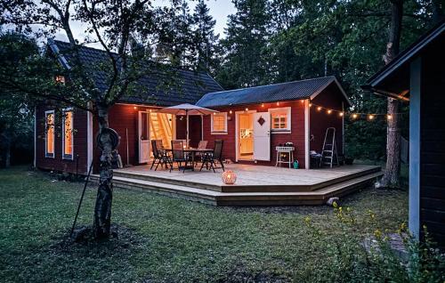 a small house with a porch and a patio at 3 Bedroom Awesome Home In Gotlands Tofta in Tofta