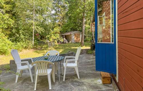 a patio with a table and chairs and a house at 3 Bedroom Awesome Home In Gotlands Tofta in Tofta