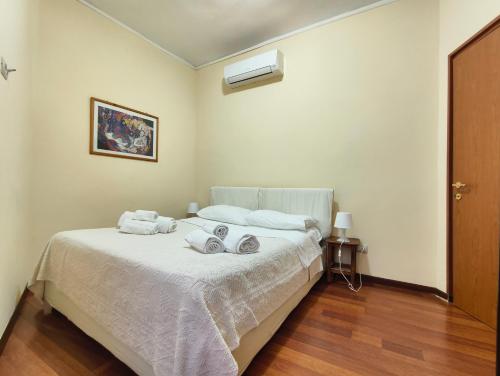 a bedroom with a bed with towels on it at Eulalia Apartment in Cagliari