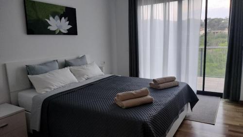 a bedroom with a bed with two towels on it at Large house surrounded by nature in Vilanova de la Roca