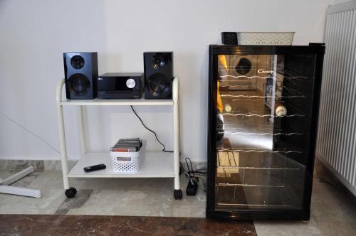 a room with a refrigerator and a table with a speaker at Villa Irini in Ancient Epidavros