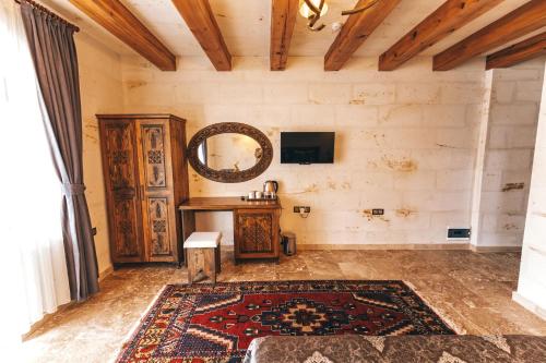 a room with a mirror and a table and a rug at Nest Cappadocia Hotel in Uchisar
