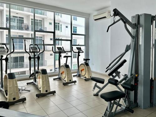 a gym with a bunch of treadmills and ellipticals at Golden Sand Couple Suites near CIQ 1B1B in Johor Bahru