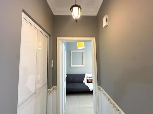 a hallway with a door and a couch in a room at Golden Sand Couple Suites near CIQ 1B1B in Johor Bahru