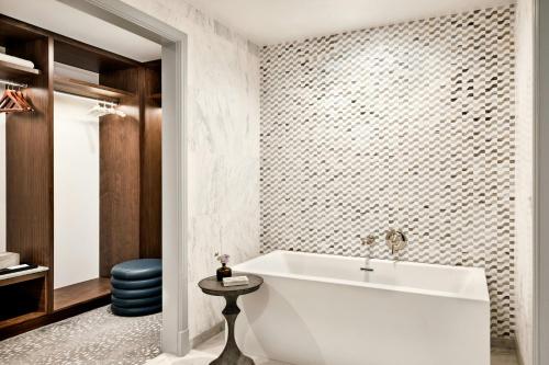 a bathroom with a white tub and a stool at The Ritz-Carlton, Laguna Niguel in Dana Point