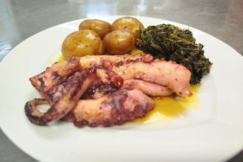 a white plate of food with meat and vegetables at Hotel Estrela Da Idanha in Idanha-a-Nova