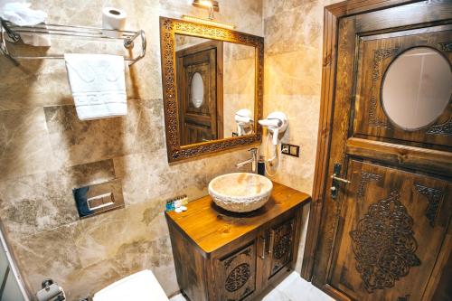 a bathroom with a sink and a mirror at Nest Cappadocia Hotel in Uchisar