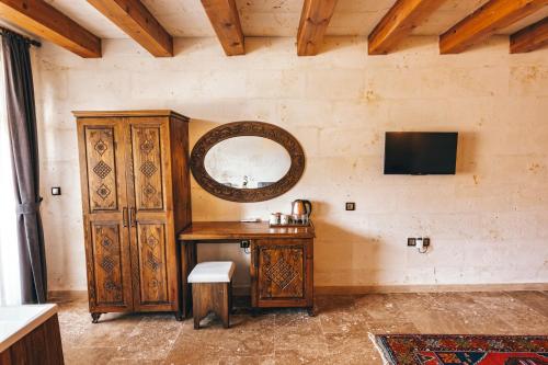 a room with a wooden table and a mirror at Nest Cappadocia Hotel in Uchisar