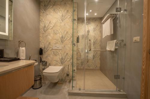 a bathroom with a shower and a toilet at World Heart Hotel in Baghdad