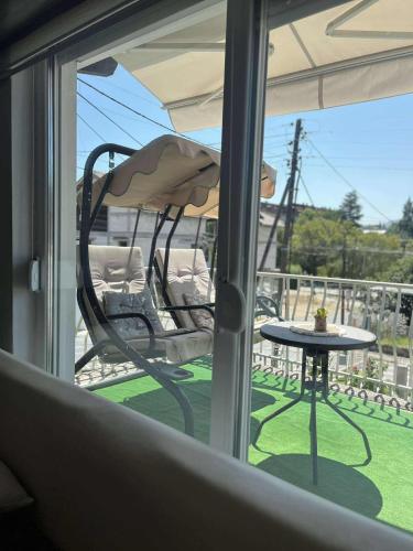 a balcony with a chair and a table and an umbrella at Stella 3 Apartment in Negotino