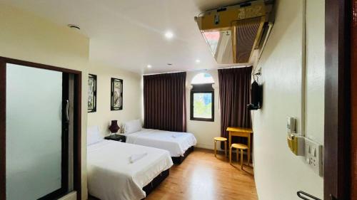Ένα ή περισσότερα κρεβάτια σε δωμάτιο στο Longzhu Guesthouse